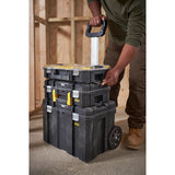 STANLEY FMST1-80101 rolling toolbox stack with three black modular cases, shown being pulled by handle in workshop.