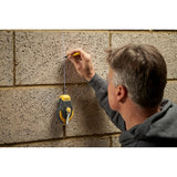 Photo of person marking a brick wall with a pencil using a STANLEY STHT47311-0 chalk line, product category photography.