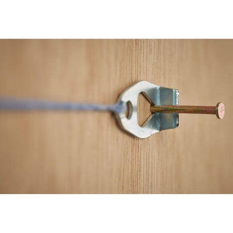 STANLEY STHT47311-0 metal wall hook with nail and string, close-up on wood surface.