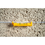 STANLEY STHT47312-0 line level, yellow plastic, shown clipped to a blue string against a textured wall, front angle.