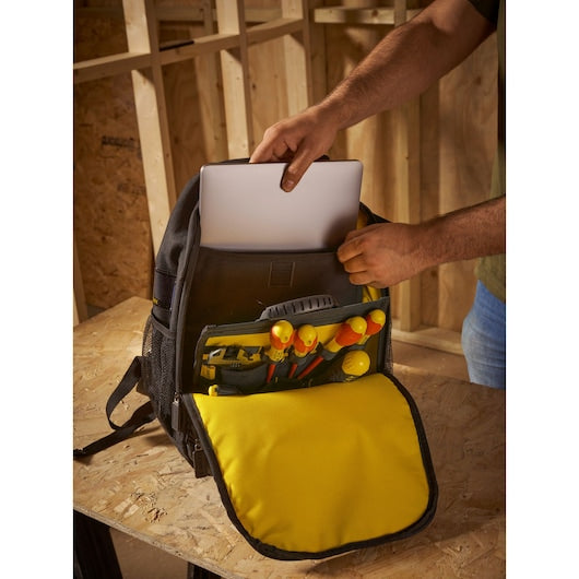 STANLEY STST1-72335 tool backpack with yellow flap, organized tools, and a laptop being placed inside.