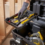 STANLEY STST1-80150 toolbox close-up with hand lifting tray holding tape measure, knife, and pliers.