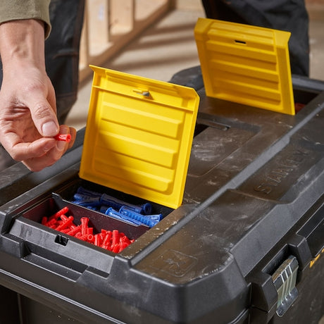 Photo of STANLEY STST1-80150 toolbox with yellow lid compartments storing red and blue wall plugs.